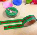 Roll of green Christmas gift wrap tape on a white background.