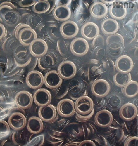 Close-up of dark brass eyelets in a pack of 1000