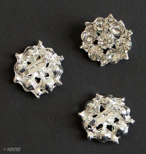 Pack of three small silver brooches with crystal embellishments.