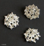 Pack of three small silver brooches with crystal embellishments.