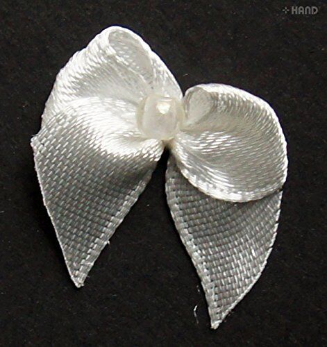 Assorted small decorative ribbon bows in white, pink, and red