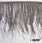 Close-up of gun grey ostrich feather fringe showing stitching detail.