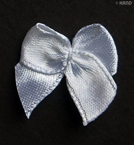 Assorted small white butterfly ribbon bows arranged for display