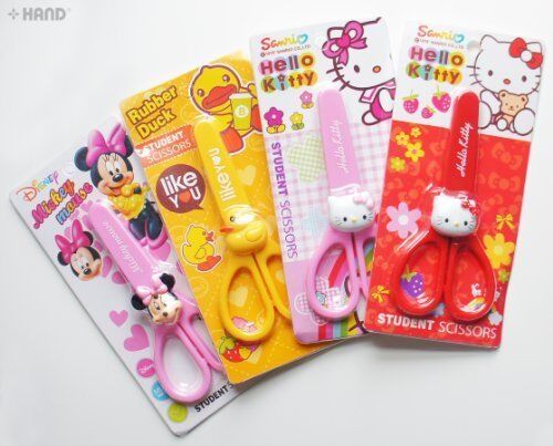 Two pairs of children's cartoon scissors with safety covers.