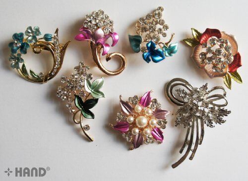 Elegant brooch with crystal rhinestones in floral design.