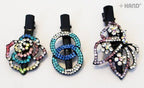 Close-up of shiny diamante hair clips in various designs.