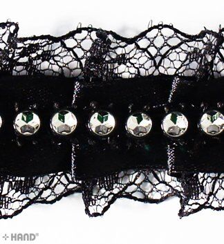 Close-up of black lace ribbon showing intricate detailing.