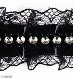 Close-up of black lace ribbon showing intricate detailing.