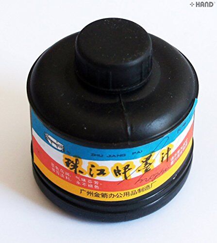 Close-up of the black ink bottle with calligraphy brush