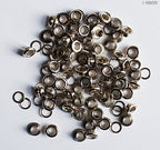 Close-up of silver eyelets grommets showing 4mm diameter.