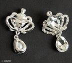Brooches arranged on a fabric surface, highlighting their sparkling finish.