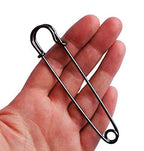 Close-up of a dark copper kilt pin showing its 102mm length.