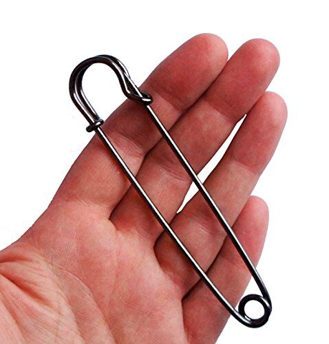Close-up of a dark copper kilt pin showing its 102mm length.