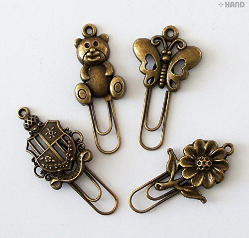 Close-up of a vintage gold metal bookmark with a decorative clip