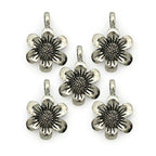 Five silver metal flower pendants on a white background.