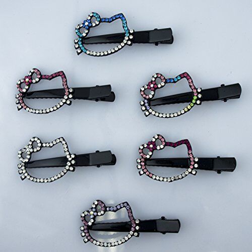 Close-up of black hair clips with colourful crystal stars motif.