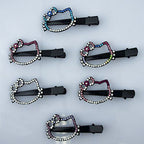 Close-up of black hair clips with colourful crystal stars motif.