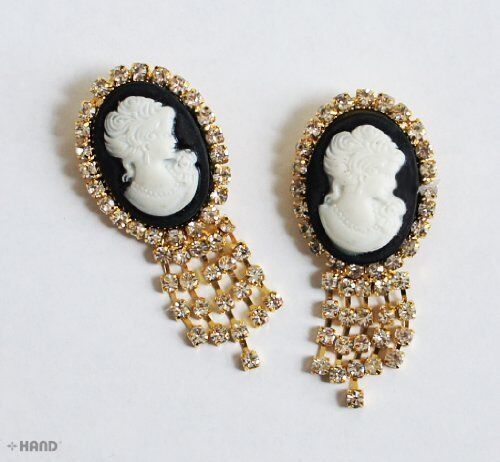 Two vintage small brooches displayed on a neutral background.
