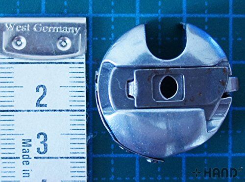 Side view of the genuine Towa bobbin case with top slot.