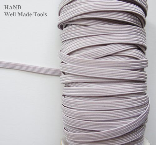 Close-up of Icy White flat elastic cord showing its stretch and texture.