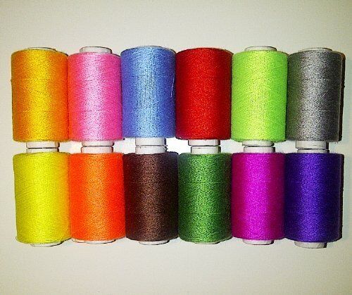 Display of 12 colourful polyester thread spools for crafting