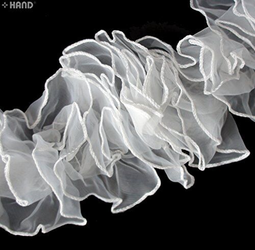 Detail of the S-shaped pattern of the white chiffon frilly trim.
