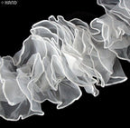 Detail of the S-shaped pattern of the white chiffon frilly trim.