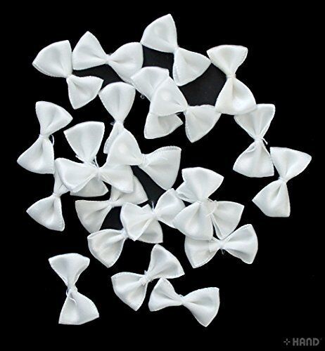 Close-up of white decorative satin ribbon bows