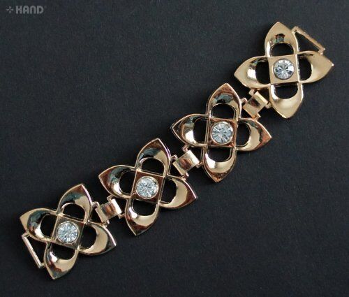 Gold tone metal embellishments with sparkling diamante gems.