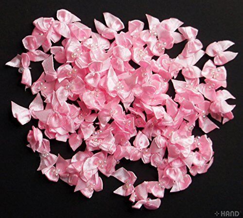 Small pink decorative craft ribbon bow with pearl trims.