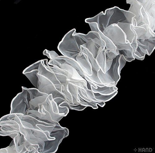 Close-up of white chiffon frilly trim showcasing its delicate design.