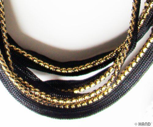 Black sew in pipe trim with gold edge on a white background