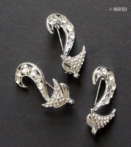 Three elegant clear crystal fox brooches displayed together.