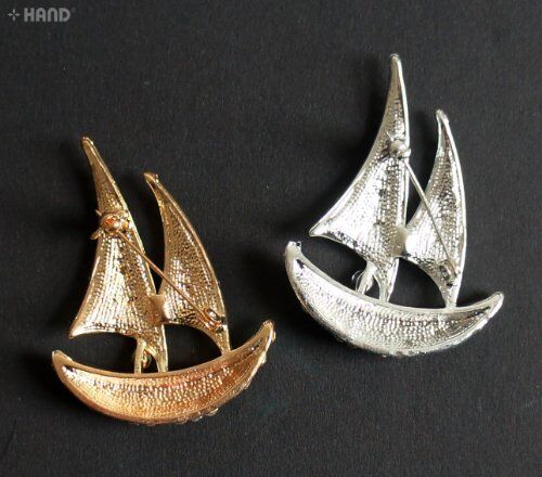 Close-up of a clear crystal boat brooch showcasing its design