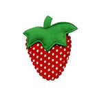 Cute dotty strawberry plush embellishments arranged on a table.