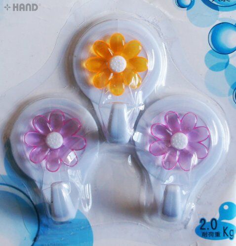 Three flower self-adhesive hooks displayed in a pack
