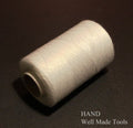Twelve spools of white 100% polyester sewing thread arranged neatly.
