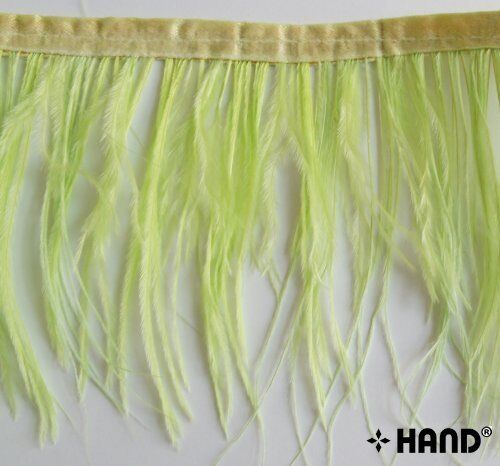 Close-up of light green ostrich feather fringe showing detailed stitching.