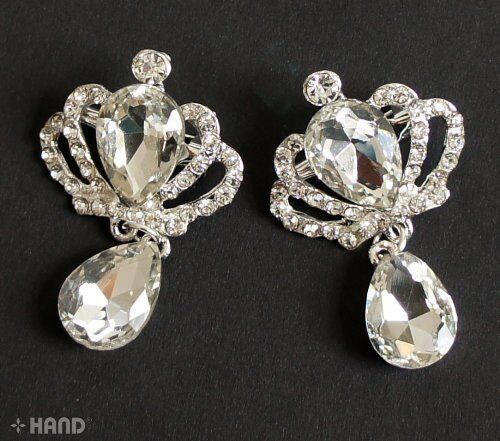 Two elegant clear crystal stone brooches displayed on a white background.
