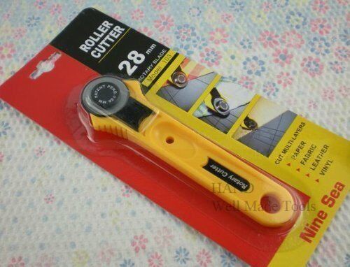 NINE SEA rotary cutter displayed on a cutting mat