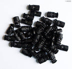 Close-up view of oval plastic toggle spring stop cord lock