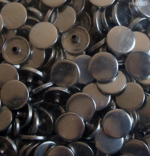 Silver press stud buttons displayed in a neat arrangement.