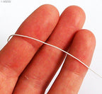 Off white shirring elastic displayed on a flat surface