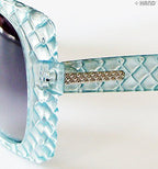 Sunglasses worn by a model outdoors, highlighting their retro style.