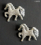 Two elegant clear crystal horse brooches displayed on a white background.