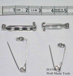 Assorted safety lock brooch pins displayed on a white background