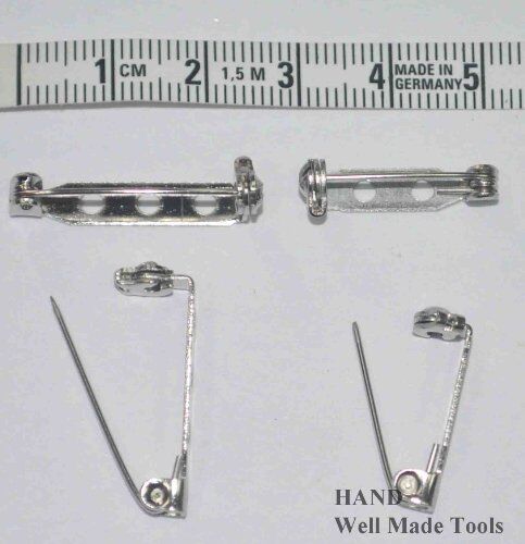 Close-up of a safety lock brooch pin showing its locking mechanism.