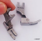 Close-up of the industrial sewing machine foot's attachment.