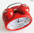 Side view of the metal bell alarm clock highlighting its design