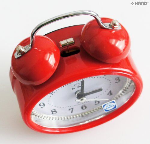 Side view of the metal bell alarm clock highlighting its design